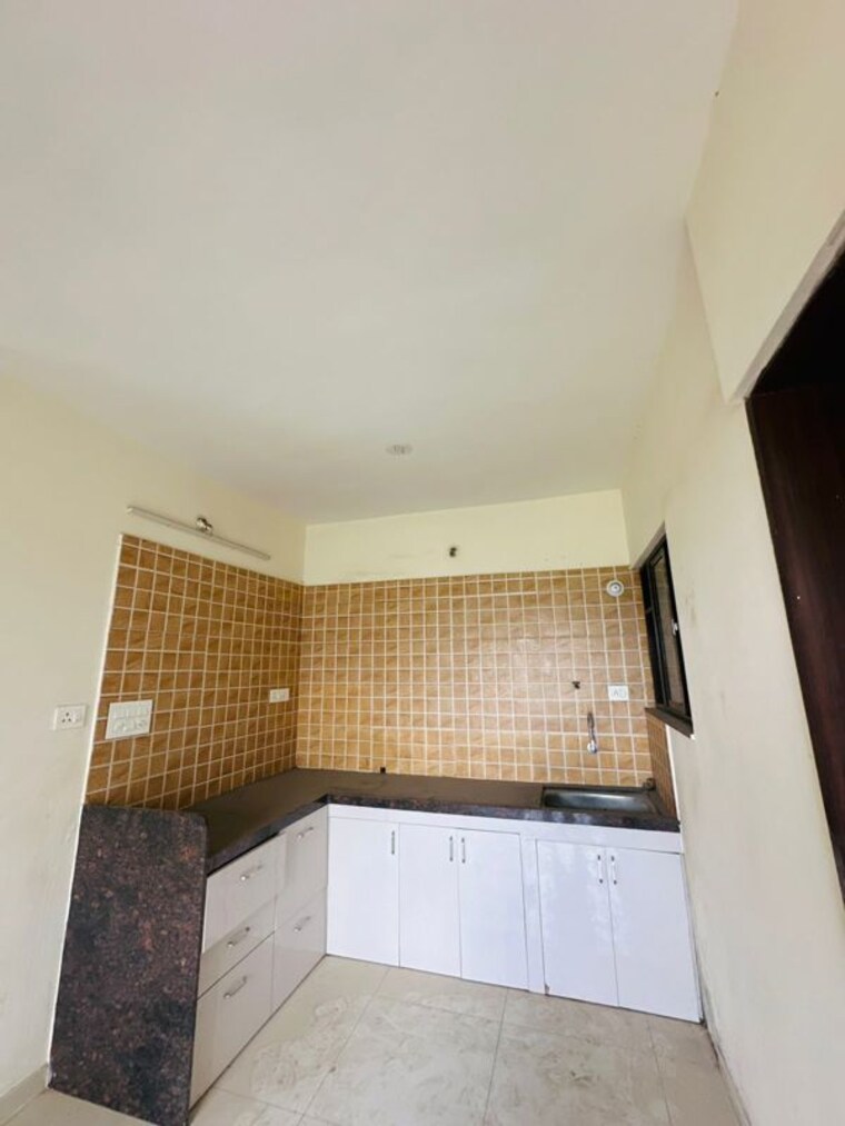 Kitchen, om-tropica 2 Bedroom 673 Sq.Ft. Apartment In Ravet Pune 10197407