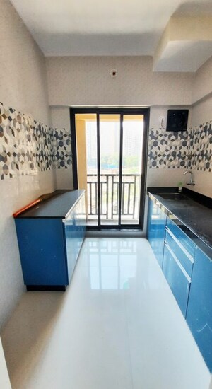 Kitchen in 1 BHK Apartment at Raunak Unnathi Woods Phase 7 A And B, Ghodbunder Road – for Rent