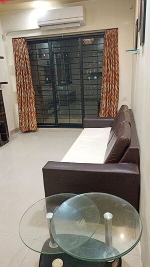 Living Room in 1 BHK Apartment at K Raheja Heights, Malad East – for Rent