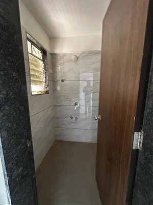 Bathroom in 1 BHK Apartment at Unnati Woods CHS, Kasarvadavali – for Rent