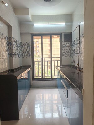 Kitchen in 1 BHK Apartment at Raunak Unnathi Woods, Ghodbunder Road – for Sale