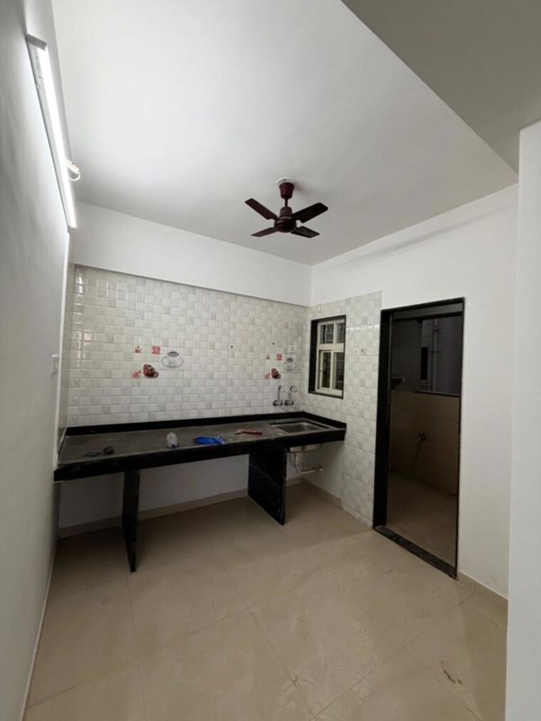 Kitchen, united-arise 2 Bedroom 850 Sq.Ft. Apartment In Lohgaon Pune 10296392
