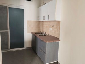 Kitchen in 2.5 BHK Apartment at Mahagun Moderne, Sector 78 – for Sale