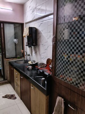 Kitchen in 2 BHK Apartment at Triveni Garden, Khadakpada – for Sale