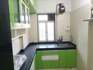 Kitchen in 1 BHK Apartment at Cosmos Classique, Ghodbunder Road – for Sale