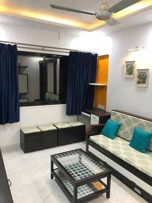 Living Room in 1 BHK Apartment at Versova Manish CHS, Andheri West – for Rent