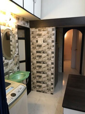 Living Room in 1 BHK Apartment at Versova Manish CHS, Andheri West – for Rent