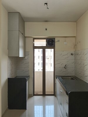 Kitchen in 2 BHK Apartment at Ram Pushpanjali Residency, Owale – for Rent