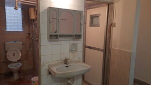 Bathroom in 2 BHK Apartment at Anuprita CHS, Andheri West – for Sale
