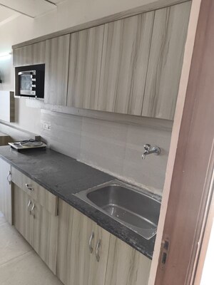 Kitchen in 1 RK Apartment at Paramount Golf Forest Studio Apartments - OAK Towe, Zeta I Greater Noida – for Rent