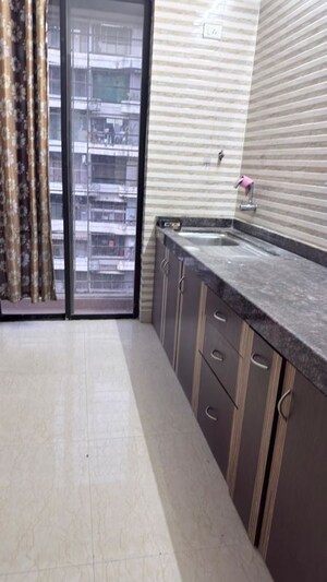 Kitchen in 1 BHK Apartment at Tharwani Vedant Millenia, Titwala – for Sale