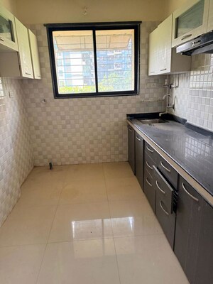 Kitchen in 2 BHK Apartment at Umiya Uma Paradise Complex, Titwala – for Sale