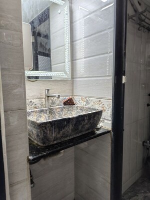 Bathroom in 2 BHK Apartment at Abrol Krishna Utsav, Malad West – for Rent
