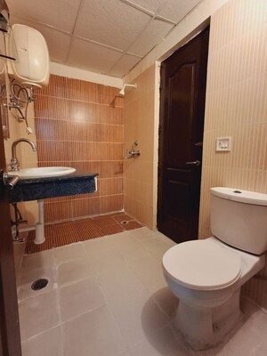 Bathroom in 2 BHK Apartment at Mahagun Mascot, Sain Vihar – for Sale