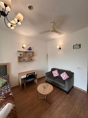 Living Room in Studio Apartment at Nimbus The Golden Palm, Sector 168 – for Rent