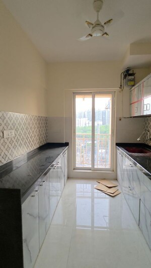 Kitchen in 2 BHK Apartment at Shree Tirupati STG Signature Residency, Patlipada – for Rent