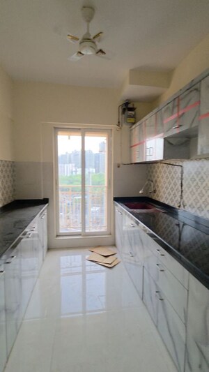 Kitchen in 2 BHK Apartment at Shree Tirupati STG Signature Residency, Patlipada – for Rent