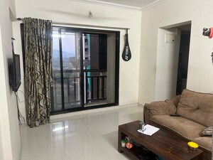 Living Room in 1 BHK Apartment at Raunak Unnathi Woods Phase 4 And 5, Ghodbunder Road – for Rent