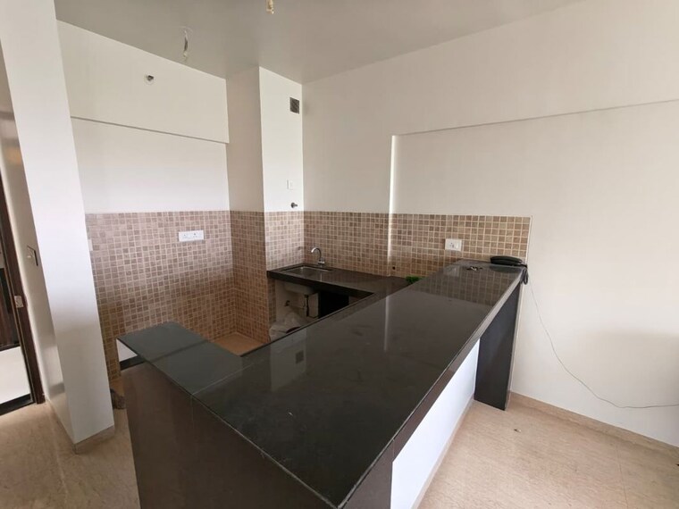 Kitchen, lodha-belmondo 1 Bedroom 500 Sq.Ft. Apartment In Gahunje Pune 10458398