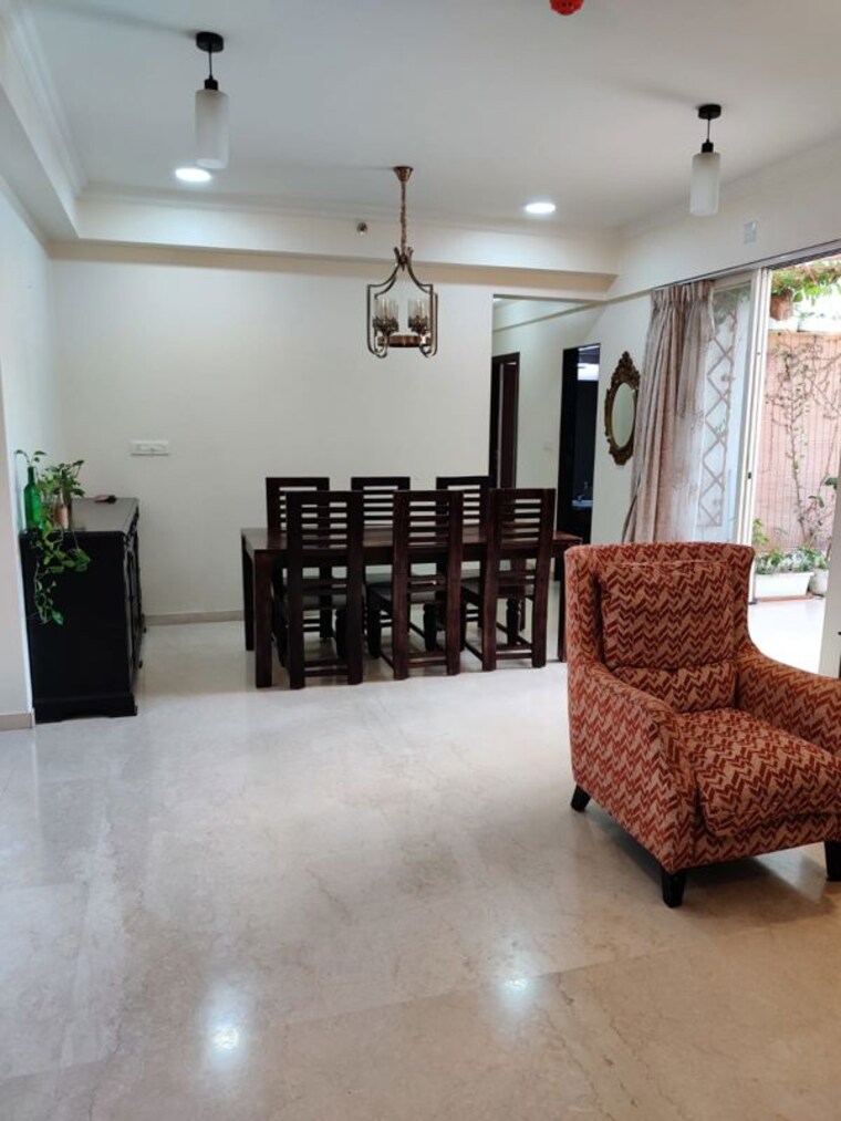 Living Room, gera-song-of-joy  1200 Sq.Ft. Apartment In Kharadi Pune 10497411