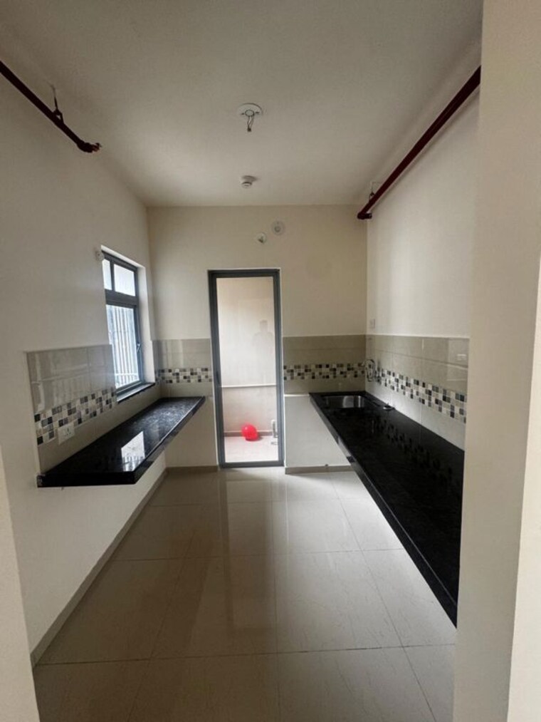 Kitchen, mahindra-happinest-tathawade-phase-1 2 Bedroom 750 Sq.Ft. Apartment In Tathawade Pune 10557141