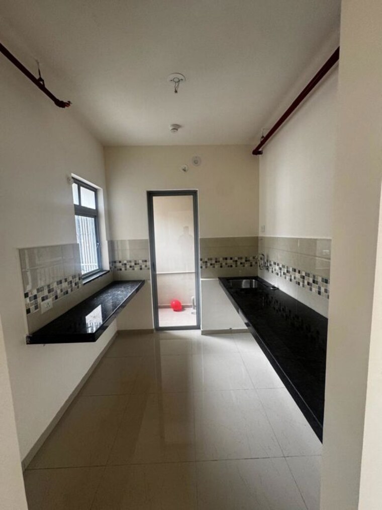 Kitchen, mahindra-happinest-tathawade-phase-1 1 Bedroom 610 Sq.Ft. Apartment In Tathawade Pune 10557155