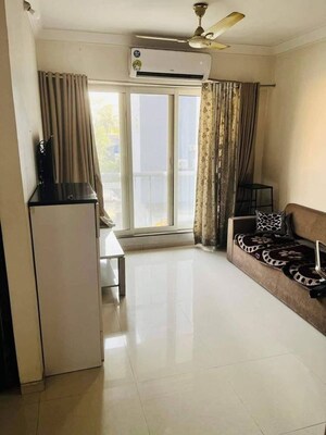 Living Room in 2 BHK Apartment at Rustomjee Elanza, Malad West – for Rent