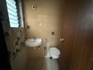 Bathroom in 1 BHK Apartment at Unnati Woods CHS, Kasarvadavali – for Rent