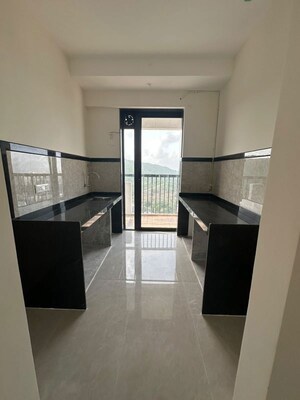 Kitchen in 2 BHK Apartment at Dhamji Shamji Mahavir Spring Tulip Phase 1, Pokhran Road No Two – for Sale