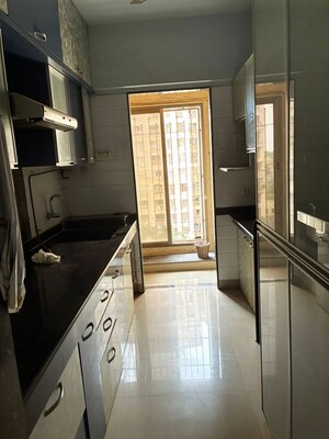 Kitchen in 1.5 BHK Apartment at Madhav Palacia, Ghodbunder Road – for Sale