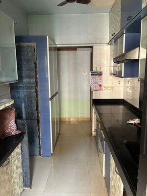 Kitchen in 1.5 BHK Apartment at Madhav Palacia, Ghodbunder Road – for Sale