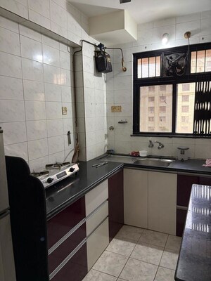 Kitchen in 2 BHK Apartment at Unnati Woods CHS, Kasarvadavali – for Rent