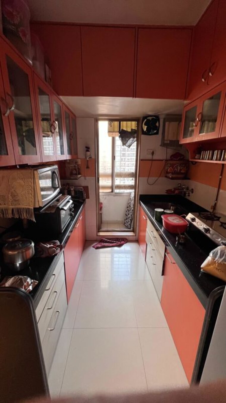 Kitchen, strawberry-sandstone 3 Bedroom 900 Sq.Ft. Apartment In Mira Road Thane 10634151
