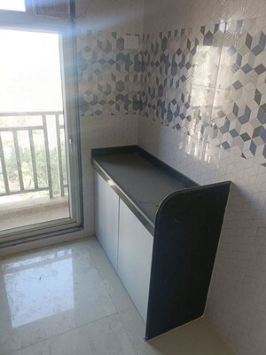 Kitchen in 1 BHK Apartment at Raunak Unnathi Woods Phase 7 A And B, Ghodbunder Road – for Rent