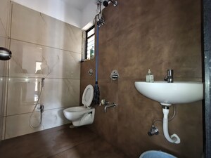 Bathroom in 1 BHK Apartment at Unnati Woods CHS, Kasarvadavali – for Rent