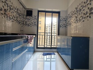 Kitchen in 1 BHK Apartment at Unnati Woods CHS, Kasarvadavali – for Rent
