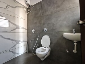 Bathroom in 1 BHK Apartment at Unnati Woods CHS, Kasarvadavali – for Rent