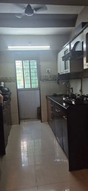 Kitchen in 2 BHK Apartment at Unnati Woods CHS, Kasarvadavali – for Rent