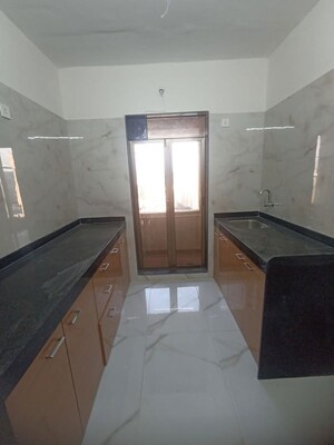 Kitchen in 2 BHK Apartment at Ram Pushpanjali Residency, Owale – for Rent