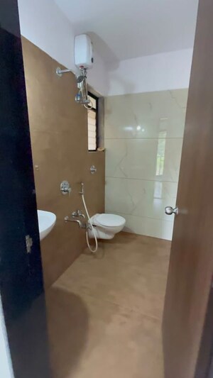 Bathroom in 1 BHK Apartment at Unnati Woods CHS, Kasarvadavali – for Rent