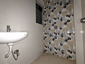 Bathroom in 1 BHK Apartment at Unnati Woods CHS, Kasarvadavali – for Rent