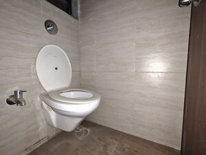 Bathroom in 1 BHK Apartment at Unnati Woods CHS, Kasarvadavali – for Rent