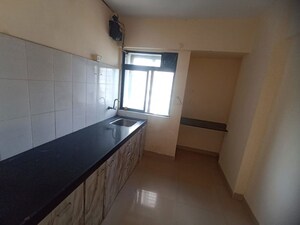 Kitchen in 2 BHK Apartment at Pushpanjali Heights, Owale – for Rent