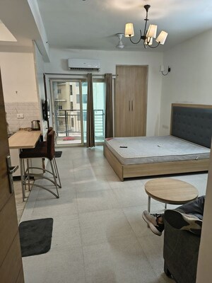 Living Room in Studio Apartment at Nimbus The Golden Palm, Sector 168 – for Rent