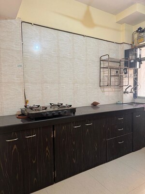 Kitchen in 1 BHK Apartment at Unnati Woods CHS, Kasarvadavali – for Rent