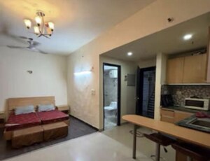 Living Room in Studio Apartment at Supertech Czar Suites, Omicron I Greater Noida – for Rent