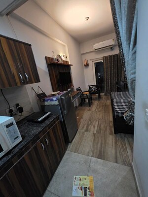 Living Room in Studio Apartment at Paramount Golfforeste, Zeta I Greater Noida – for Rent