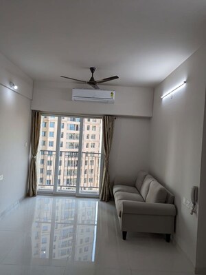 Living Room in 2 BHK Apartment at Rustomjee Urbania Azziano, Thane West – for Rent