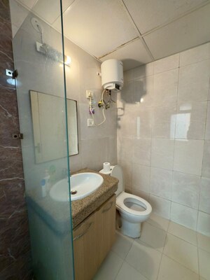 Bathroom in 1 RK Apartment at Nimbus The Golden Palm, Sector 168 – for Rent