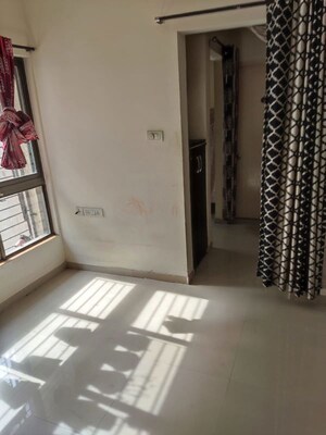 Living Room in 1 BHK Apartment at Lodha Palava City, Dombivli East – for Rent